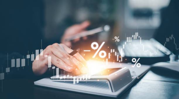 Businessperson calculating VAT returns with a calculator, surrounded by percentage symbols and financial graphs, representing tax and accounting analysis.