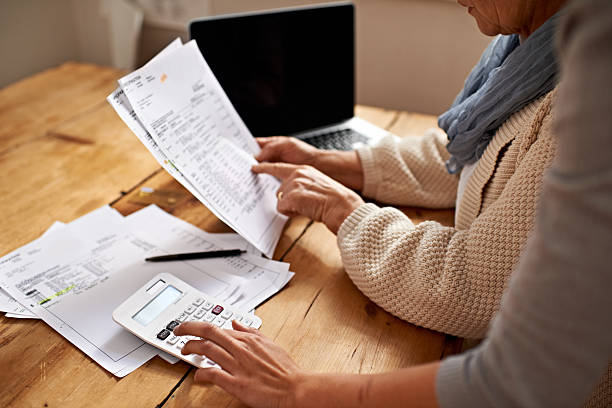 Reviewing financial documents and using a calculator for accurate P11D form completion